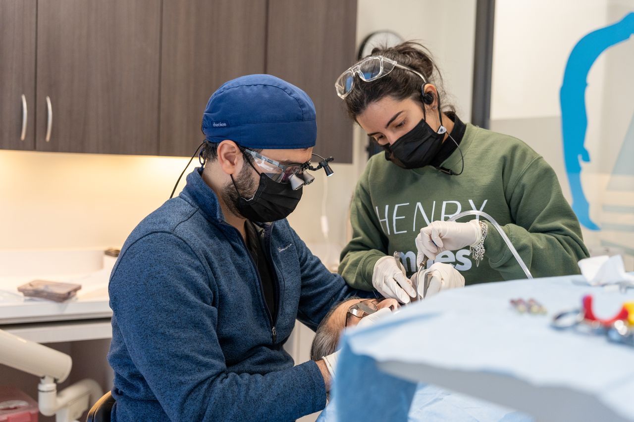 dental hygienist performing periodontal maintenance cleaning at Henry Smiles Dental