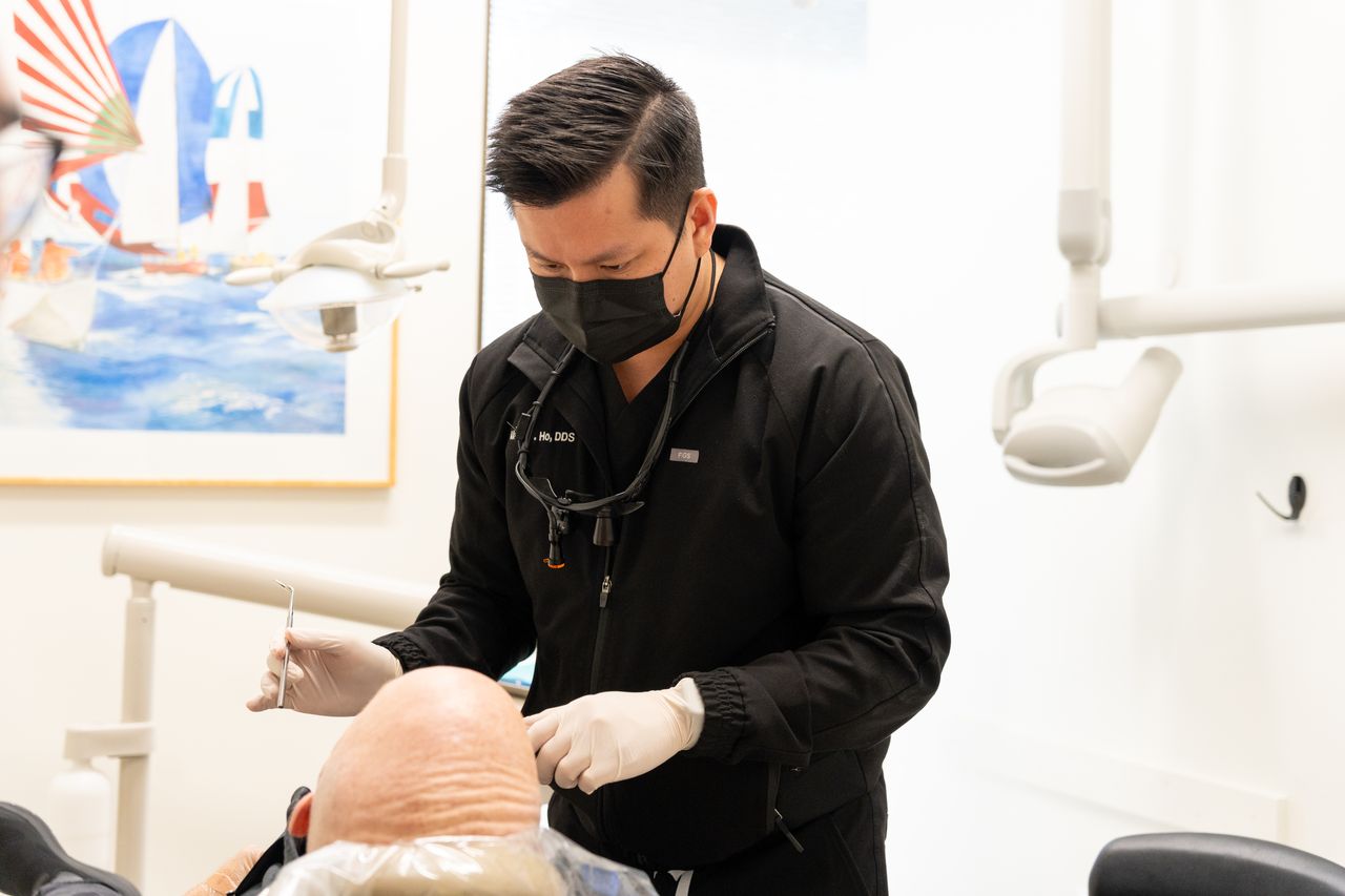Dentist evaluating a patient for CPAP alternatives in Houston at Henry Smiles Dental