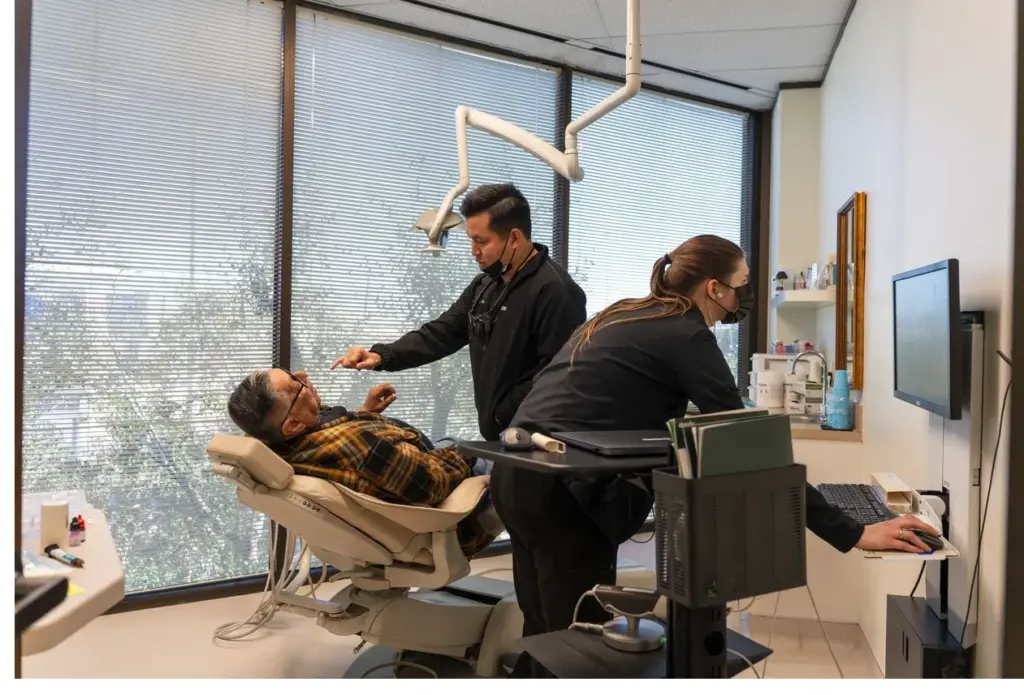 Houston dentist discussing CPAP alternatives with a patient at Henry Smiles Dental
